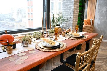 The concept of designing a room in a natural style. Photo of a beautifully furnished interior with decorative elements on the table in a rustic image of a cozy house.