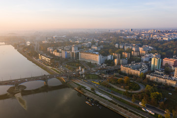 Fototapeta na wymiar Warsaw, Poland. 26. October. 2019. Cityscape with skyscrapers and knowledge and roads at sunrise. Aerial view of the river and the city with skyscrapers and buildings in the early morning.
