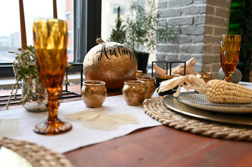 The concept of designing a room in a natural style. Photo of a beautifully furnished interior with decorative elements on the table in a rustic image of a cozy house.
