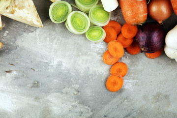 Vegetables cooking ingredients for tasty vegetarian soups. Carrot , onion , garlic , parsley on rustic background