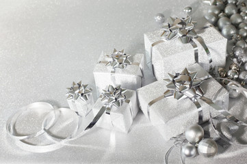 Silver holiday gifts on glitter background