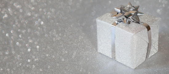 Silver holiday gifts on glitter background