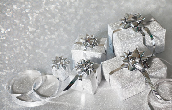 Silver holiday gifts on glitter background