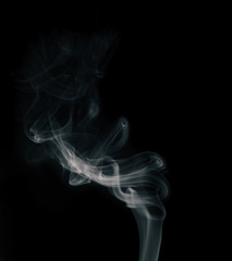 Movement of white smoke isolated on black background.Abstract shape and curve of smoke.