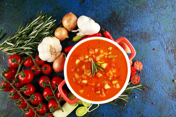 Minestrone soup in a bowl on a light table, top view. Italian soup with pasta and seasonal...