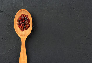 Dry barberry in spoon