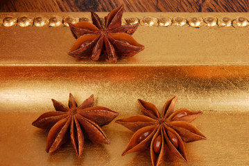 close up of anise on golden plate