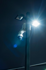 Luminous street lighting with a security camera, Luminous street lighting, Street lantern at night