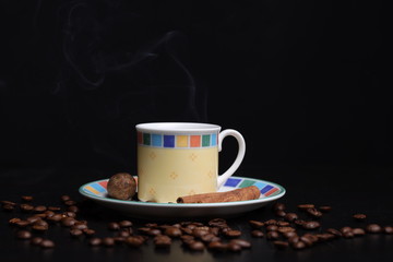 cup of natural coffee garnished with cinnamon and nutmeg