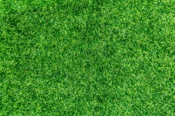 Artificial green grass low height close-up. Closeup of artificial grass made of plastic.