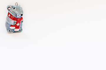 Obraz premium Ceramic figurine of a Christmas rat on a white background. Symbol of the new year 2020.