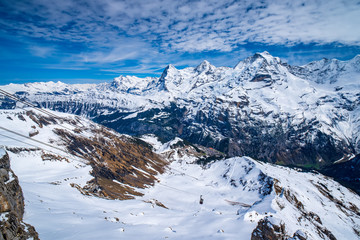 Breathtaking panoramic view of famous peaks Eiger, Monch and Jungfrau in Swiss Alps, Switzerland