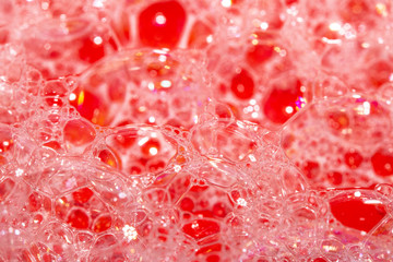 Close Up of Bath Water Bubbles Foam For Background In Red Pink