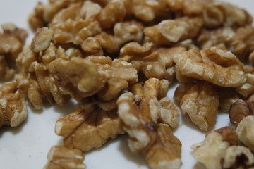 Close-up top view of peeled walnut on a white background