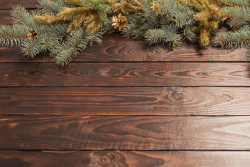 Christmas fir branches  on old dark wooden background
