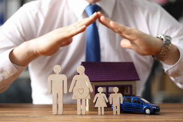 Wooden silhouette famiy against insurance agent