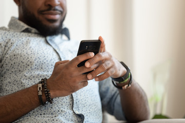 Close up of biracial male using cellphone texting
