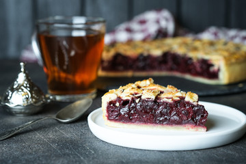 Delicious Homemade Cherry Pie with a Flaky Crust on dark background