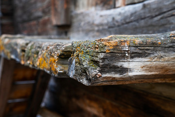 Weathered old wood texture background. Part of the wall wooden house in village in Swiss Alps. The barns, stores, stables and old houses. Timber wood wall texture background.