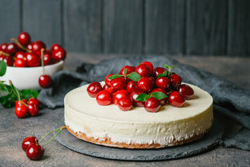 Delicious Homemade Cherry Pie with a fresh berries on dark background.