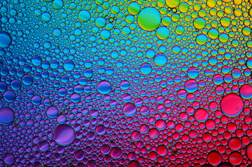 Background of colorful oil drops in water surface - abstraction