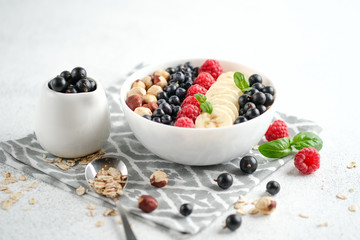 Oatmeal with berries and fruits on a light background. Healthy breakfast.