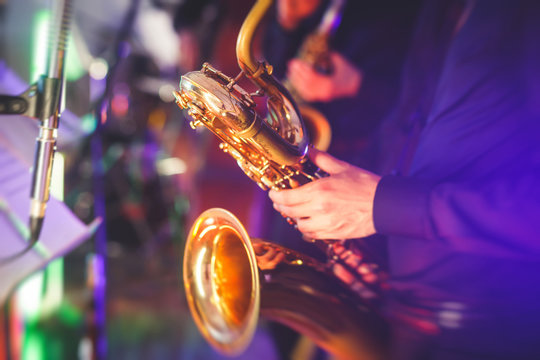 Concert View Of A Saxophone Player With Vocalist And Musical Jazz Band In The Background