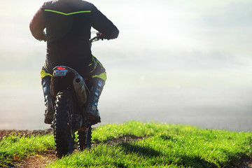man doing motocross in the countryside in autumn