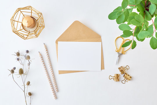 Mockup White Greeting Card And Envelope With Branches With Green Leaves On A Light Background