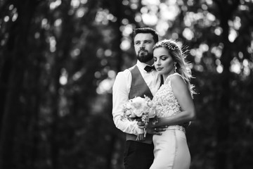 Sensual Black and white foto of bride and groom. Stylish couple of happy newlyweds posing and...