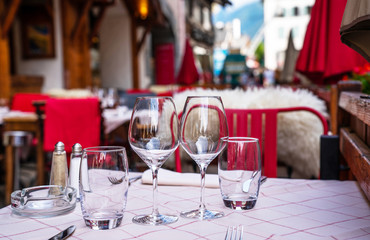 Cozy street with tables of cafe old town street in Chamonix village, France. Architecture and landmark. Cozy cityscape. Typical view of the street with tables of cafe in Chamonix.