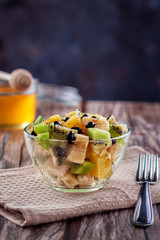 Fresh fruit salad for a healthy diet on wooden background