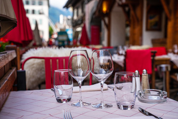 Cozy street with tables of cafe old town street in Chamonix village, France. Architecture and landmark. Cozy cityscape. Typical view of the street with tables of cafe in Chamonix.