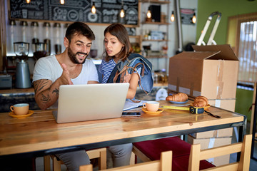 working in the coffee store.man and woman ready to open their cafe.