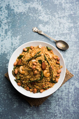 Oats Chivda / Chiwda is a healthy indian recipe with added chilli, peanuts, cashew, almond and curry leaf for flavour. Selective focus