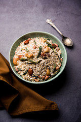 Oats Chivda / Chiwda is a healthy indian recipe with added chilli, peanuts, cashew, almond and curry leaf for flavour. Selective focus