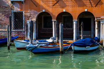 Fototapeta na wymiar Venice, Italy. View on canal with boat and motor boat. Picturesque landscape. Travel, tourism and holiday concept.