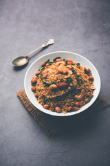 Oats Chivda / Chiwda is a healthy indian recipe with added chilli, peanuts, cashew, almond and curry leaf for flavour. Selective focus