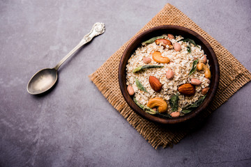 Oats Chivda / Chiwda is a healthy indian recipe with added chilli, peanuts, cashew, almond and curry leaf for flavour. Selective focus