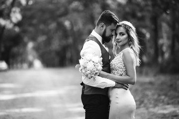 Sensual Black and white foto of bride and groom. Stylish couple of happy newlyweds posing in the...