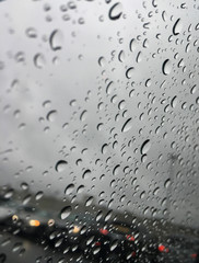 Water droplets on glass in a parking lot