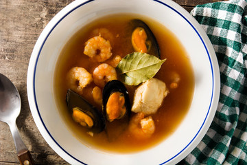 French bouillabaisse soup on wooden table. Top view
