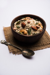 Oats Chivda / Chiwda is a healthy indian recipe with added chilli, peanuts, cashew, almond and curry leaf for flavour. Selective focus