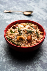 Oats Chivda / Chiwda is a healthy indian recipe with added chilli, peanuts, cashew, almond and curry leaf for flavour. Selective focus
