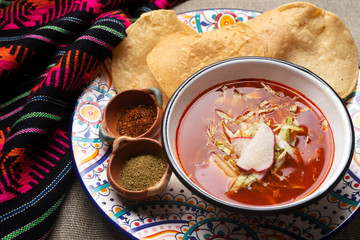 Mexican red pozole on rustic background