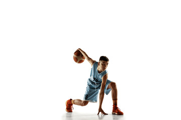 Fototapeta na wymiar Full length portrait of young basketball player with a ball isolated on white studio background. Teenager training and practicing in action, motion. Concept of sport, movement, healthy lifestyle, ad.