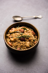 Oats Chivda / Chiwda is a healthy indian recipe with added chilli, peanuts, cashew, almond and curry leaf for flavour. Selective focus