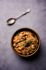 Oats Chivda / Chiwda is a healthy indian recipe with added chilli, peanuts, cashew, almond and curry leaf for flavour. Selective focus