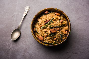 Oats Chivda / Chiwda is a healthy indian recipe with added chilli, peanuts, cashew, almond and curry leaf for flavour. Selective focus