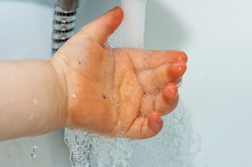Fototapeta premium Child washing his hands